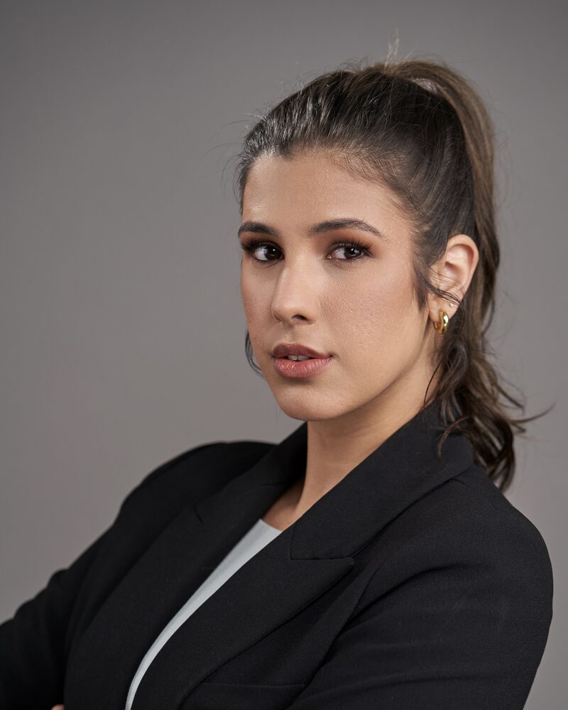 Jeannet Garcia professional headshot — black blazer, arms crossed